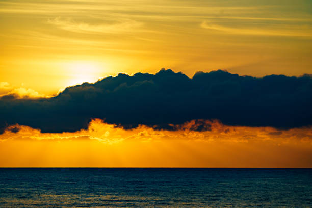 Seascape. Sunrise over sea water. Sun rising above horizon.