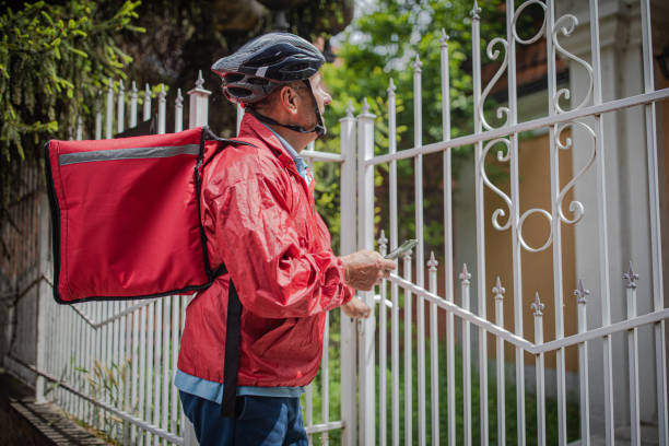 istock An elderly man works as a professional food delivery man 2156518493