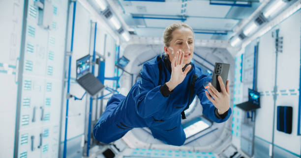 istock Woman in Space Talking on a Phone While Flying in Zero Gravity in A Satellite. Astronaut Chatting with Mission Control, Family At Home or Work Colleagues on a Video Call App on a Smartphone. 2156518496