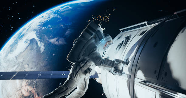 istock Space Technician Mending a Panel on an International Space Station with an Automatic Screw Gun. Fearless Astronaut Working in Outer Space with Beautiful Planet Earth in the Background 2156518556