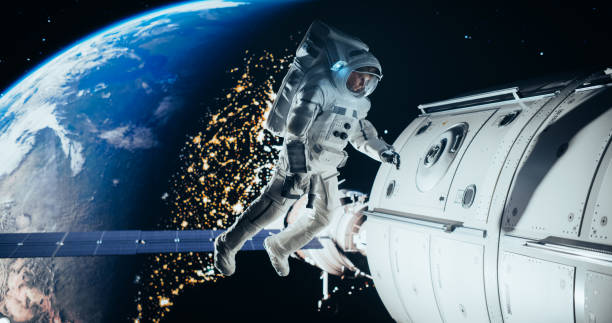 istock Space Technician Mending a Panel on an International Space Station with an Automatic Screw Gun. Fearless Astronaut Working in Outer Space with Beautiful Blue Planet in the Background 2156518602