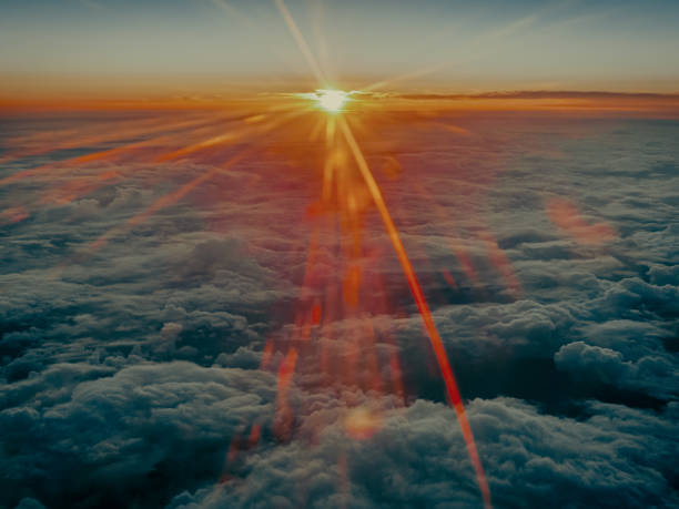 istock Radiating golden sunset above the high-altitude clouds on the flight from Asahikawa, Hokkaido, Japan 2156518607