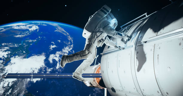 istock Portrait of a Handsome Young Astronaut Investigating a Satellite in Outer Space. Trained Professional in a Space Suit Performing Extravehicular Activity Outside the Spacecraft 2156518882