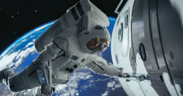 istock Astronaut on an Extravehicular Mission in Outer Space. Courageous Man Holding by the Handle, Inspecting the Space Station During Service Procedure. Blue Planet Earth Rotating in the Background 2156520536