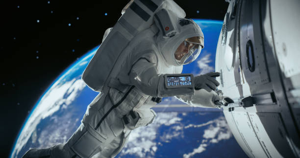 istock Astronaut on an Extravehicular Mission in Outer Space. Courageous Man Holding by the Handle, Inspecting the Space Station During a Service Procedure. Planet Earth Rotating in the Background 2156520561