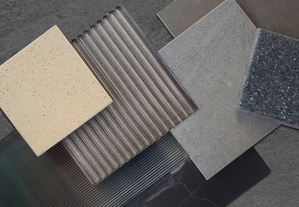 istock combination of interior material samples for modern loft style concept including corrugated glasses, grainy quartz, stone ceramic tiles, black marble placed on grey concrete background. 2156520593