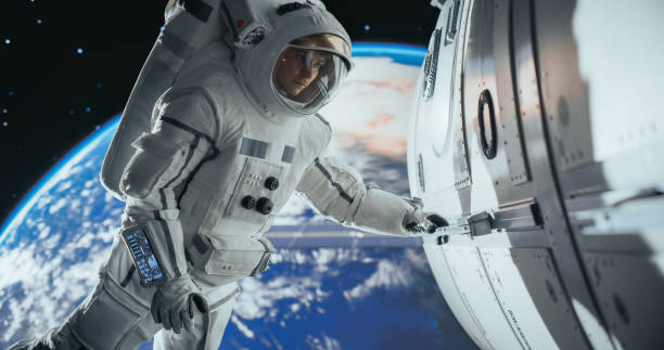 istock Astronaut on an Extravehicular Mission in Outer Space. Courageous Man Holding by the Handle, Inspecting the Space Station During a Service Procedure. Blue Planet Earth Rotating in the Background 2156520595