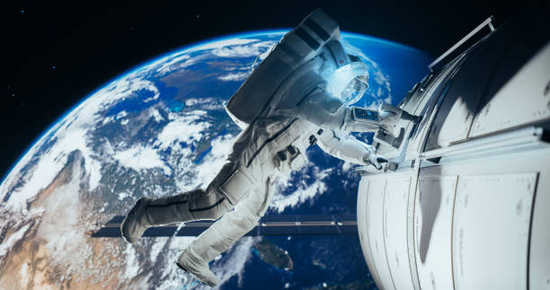 istock Astronaut on an Extravehicular Mission in Outer Space Far From Planet Earth. Courageous Man Holding by the Handle, Slowly Moving Outside the Space Station During a Service Procedure in Zero Gravity 2156520630