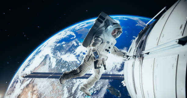 istock Astronaut on an Extravehicular Mission in Outer Space Far From Planet Earth. Brave Man Holding by the Handle, Slowly Moving Outside the Space Station During a Service Procedure in Zero Gravity 2156520631