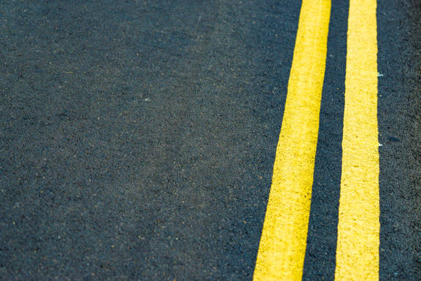 Aerial top view. Asphalt road with yellow line marks