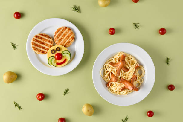 istock Fun Kids Meal: Spaghetti with Octopus Sausages and Meat Patties with Mashed Potatoes on a Playful Green Background 2156526865