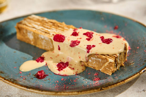 istock Close-up of Authentic Medovik Cake with Sauce in Sunlit Still Life Setting 2156526895