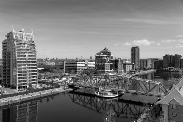 View across Salford Quays, Manchester, UK.  People can be seen on the promenade