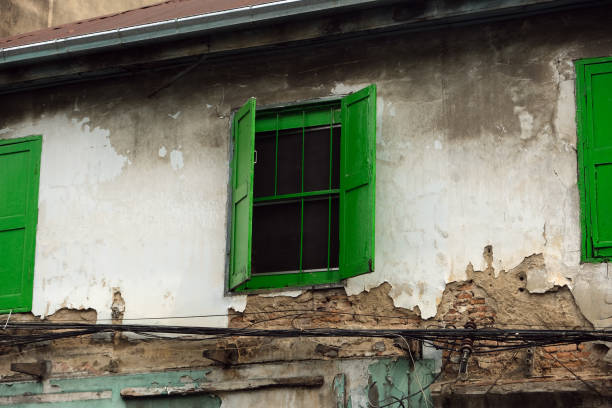 old building with green shutters on the windows