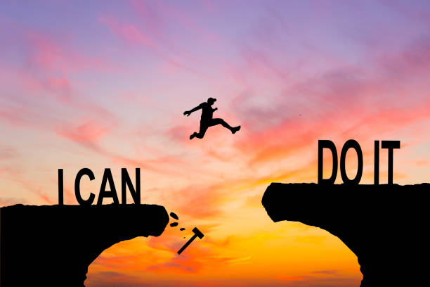istock Man jumping on I can do it or I can't do it text over cliff on sunset background, Business concept idea 2156543193