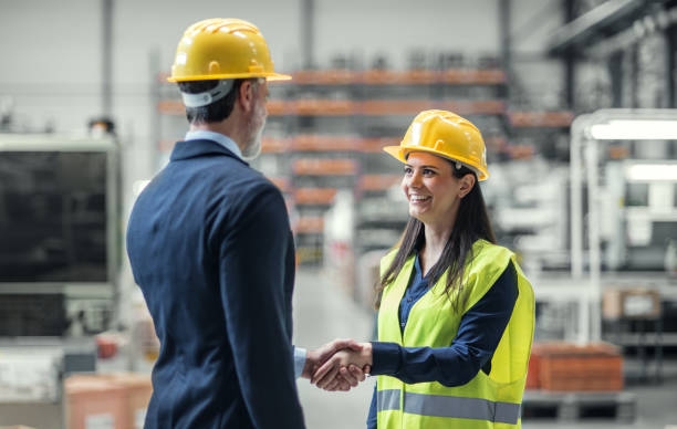 istock Warehouse worker shaking hand with logistics employee in warehouse, planning transport of products, goods, talking shipping process. 2156551739