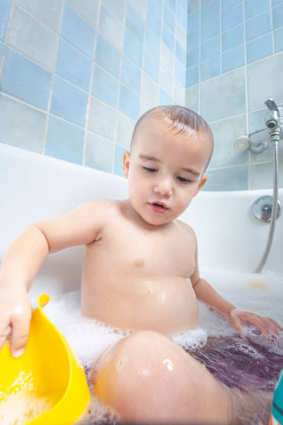 istock Toddler playing with the bath water. Innocence and joy in routine 2156553357