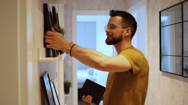 istock Young man arranging his new home 2156556192