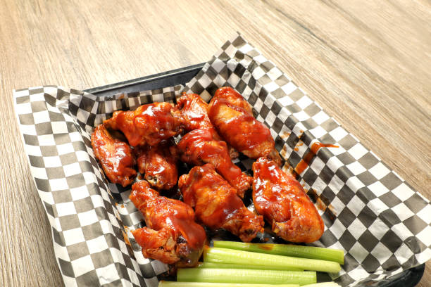 istock Fried hot chicken wings dish on wooden table 2156557642