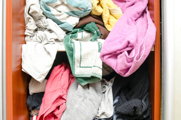 An organized setup of recyclable materials, including glass jars, plastic bottles, paper, and clothing for donation, promoting an eco-friendly and sustainable lifestyle.