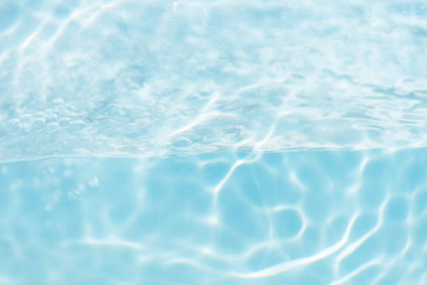 istock Blue water with ripples on the surface. Defocus blurred transparent blue colored clear calm water surface texture with splashes and bubbles. Water waves with shining pattern texture background. 2156561208