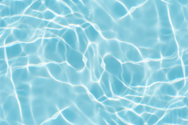 istock Blue water with ripples on the surface. Defocus blurred transparent blue colored clear calm water surface texture with splashes and bubbles. Water waves with shining pattern texture background. 2156561360