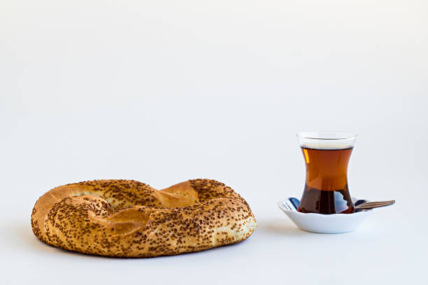Close-up taken of Traditional Turkish Classic Tea on white surface with sesame bagels,simit