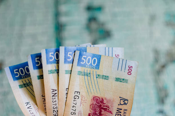 Two thousand five hundred Mexican pesos on a wooden table, banknotes