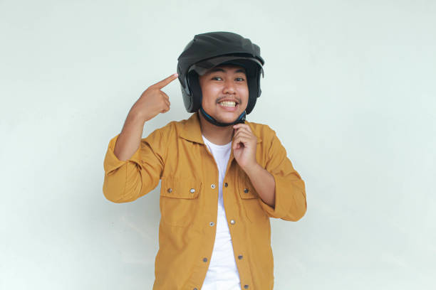 istock Young Asian man smiling and confidence gesture while wear a motorcycle helmet. 2156563230