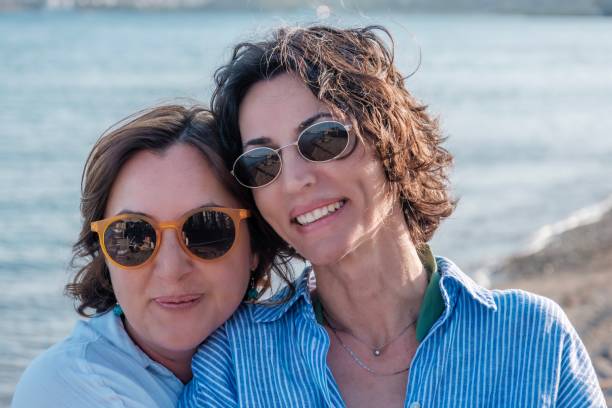 istock 2 romantic female couple on the beach. 2156564714
