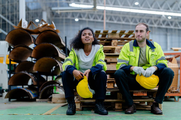 istock workers engineering sitting after work with working suite dress and hand glove in the front machine. Concept of smart industry worker are resting. 2156566103