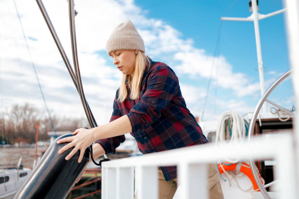 istock Sailor Woman Attaching a Fender to a Boat 2156569978