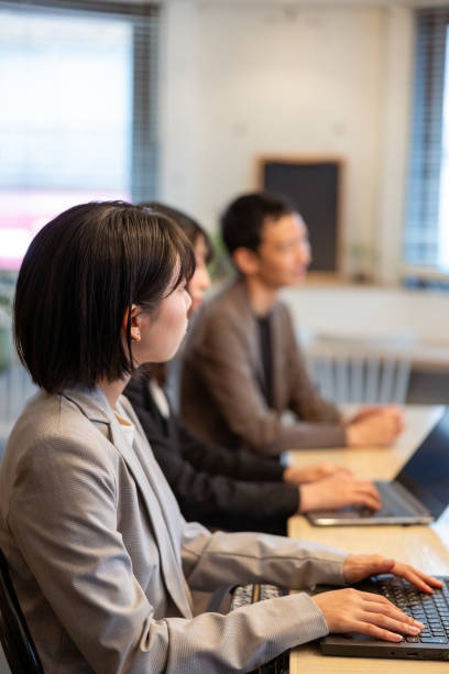 istock Group of people working together in cafe / co-working space 2156571050