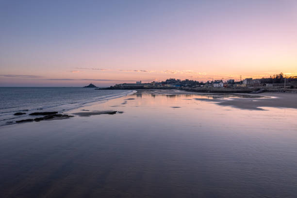 Overlooking the beache and waves along the dusk coastline