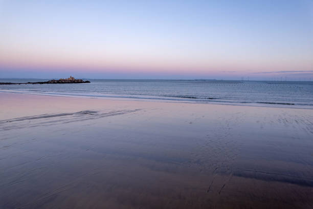 Overlooking the beache and waves along the dusk coastline