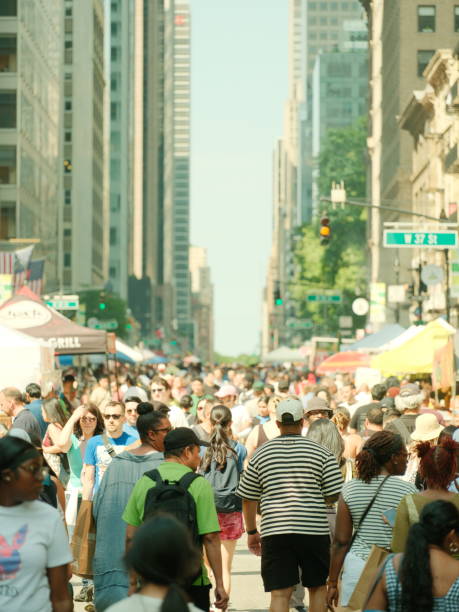 New York City, NY, USA - 26 May 2024 What the day brings on roads closed for Memorial Day events. People, crowds and various events. Crowd marches down 6th Avenue