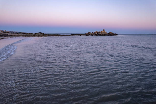 Overlooking the beache and waves along the dusk coastline