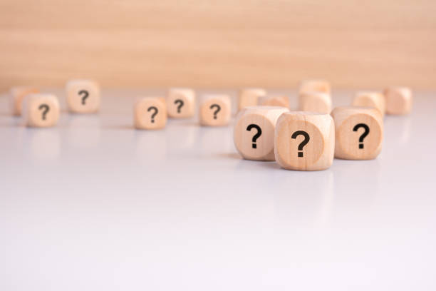 istock three wooden blocks with question marks over a gray background with copy space 2156575125