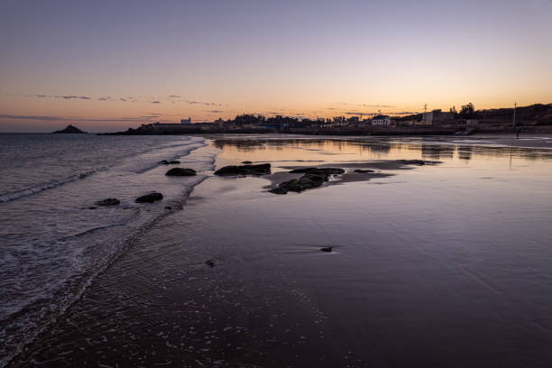 Overlooking the beache and waves along the dusk coastline