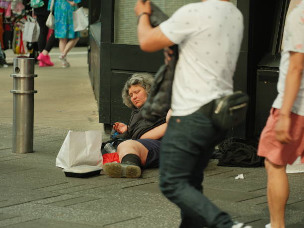 New York City, NY, USA - 26 May 2024 What the day brings on roads closed for Memorial Day events. People, crowds and various events. A woman homeless in Times Square