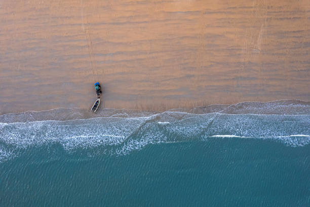 istock Overlooking the fishing boat and waves perched on the beach 2156576396
