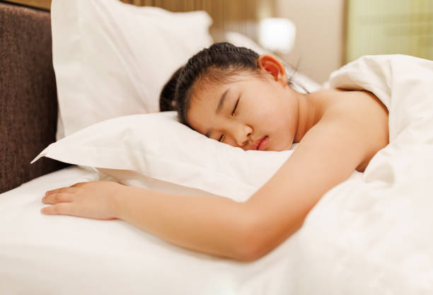 istock Little girl sleeping in hotel 2156578320