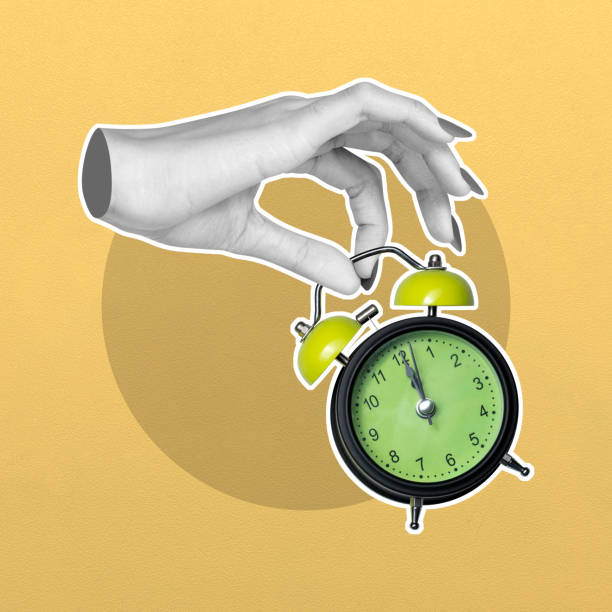 istock Hand setting time on a vintage alarm clock 2156579615