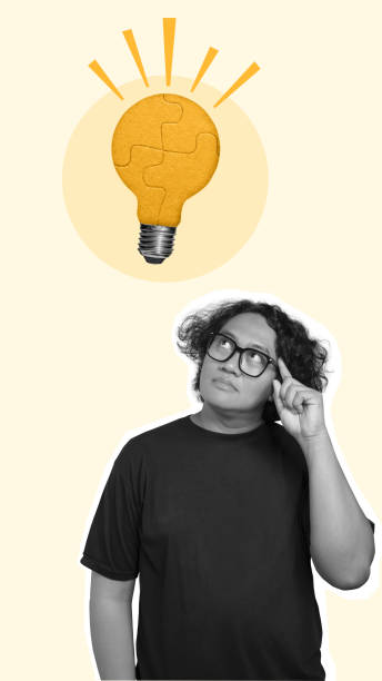 istock Man thinking of something with a light bulb puzzle as a symbol for new ideas 2156579673