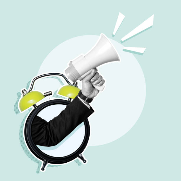 istock Business hand through alarm clock holding megaphone 2156579952