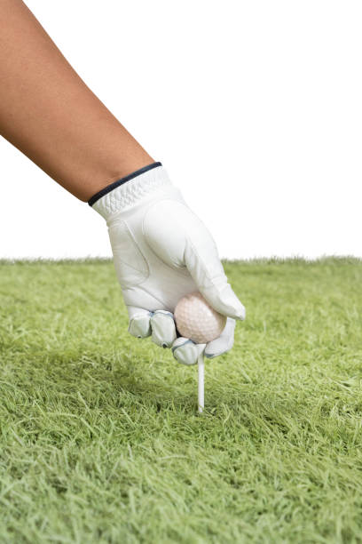 Closeup of golfer wearing glove placing golf ball on tee at golf course