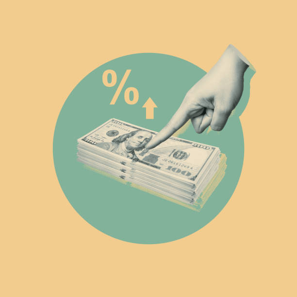 istock Hand pointing at cash stack with rising interest symbol 2156580330