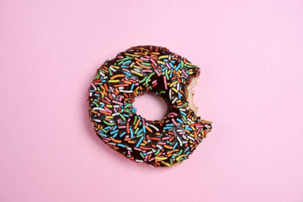 istock Delicious donut with a colorful sprinkle decoration bitten 2156581493