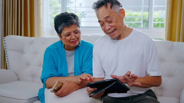 istock Senior couple, Communication, technology and elderly male in retirement resting while on tablet conversation at home. 2156581770