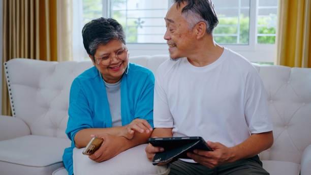 istock Senior couple, Communication, technology and elderly male in retirement resting while on tablet conversation at home. 2156582007